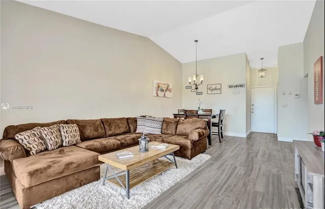 a living room with furniture and a chandelier