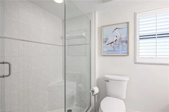 a bathroom with a toilet and a shower