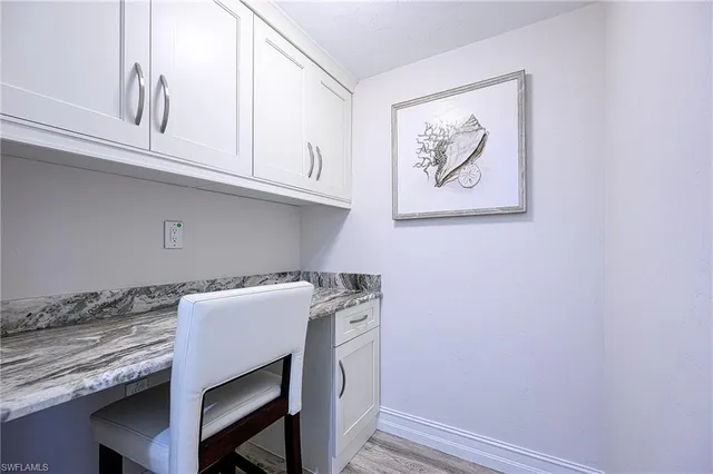 a utility room with granite countertop cabinets washer and dryer
