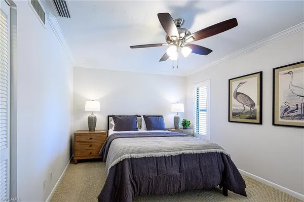 a bedroom with a bed and a ceiling fan