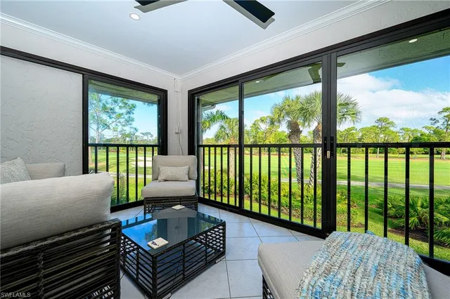 a living room with furniture and a floor to ceiling window
