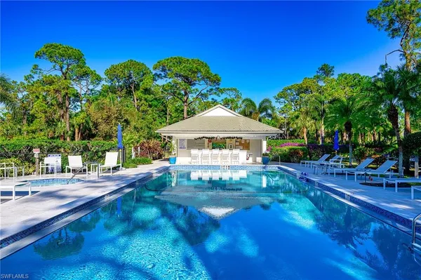 a view of swimming pool with outdoor seating and plants