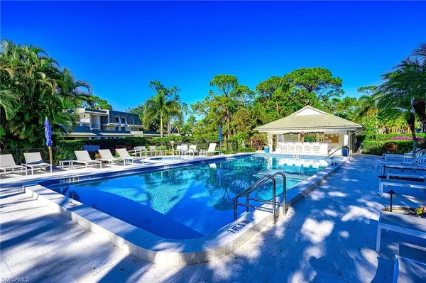 a view of swimming pool with outdoor seating