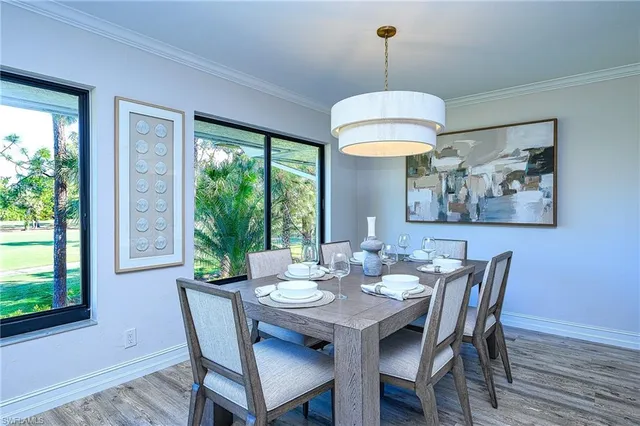 a dining room with furniture window and wooden floor