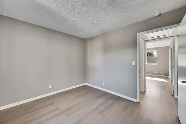 a view of a room with wooden floor
