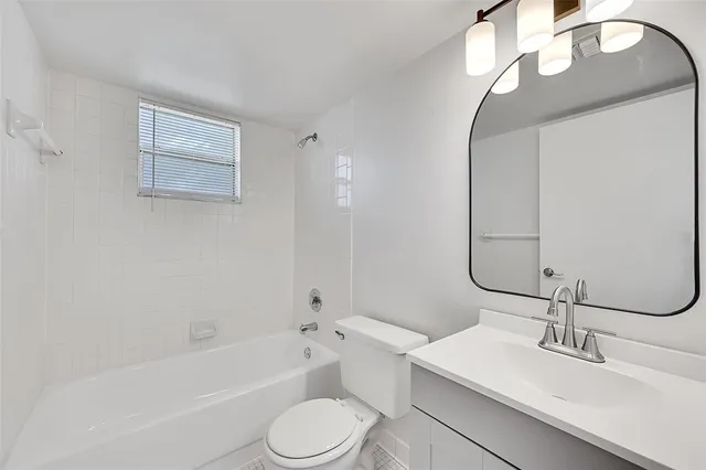 a bathroom with a sink a toilet and bathtub