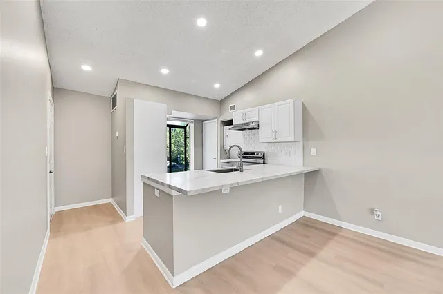 a view of kitchen with center island and stainless steel appliances