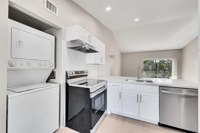 a kitchen with a stove oven and sink