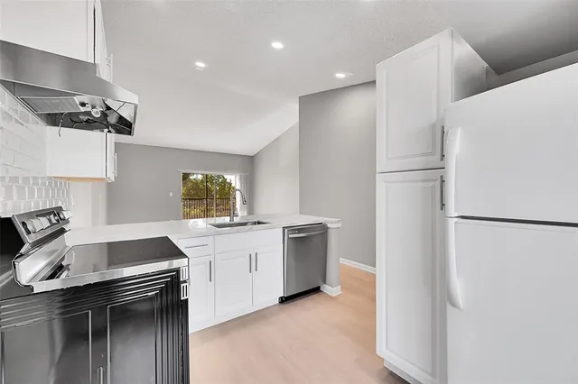 a kitchen with a sink and a refrigerator