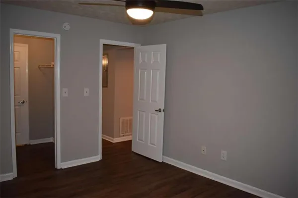 an empty room with wooden floor and closet