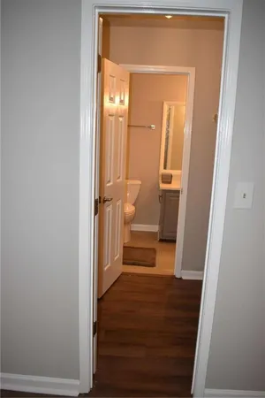 a view of entryway and hall with wooden floor