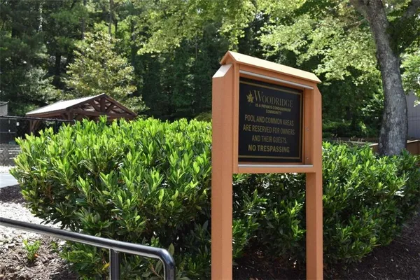 a view of a patio with table and chairs under an umbrella
