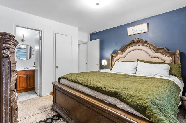 a bedroom with a bed and a view of bathroom