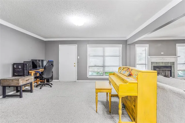 a view of a livingroom with workspace and a window