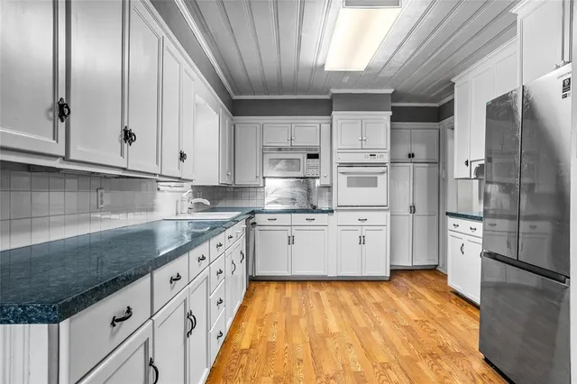 a kitchen with granite countertop stainless steel appliances and wooden cabinets