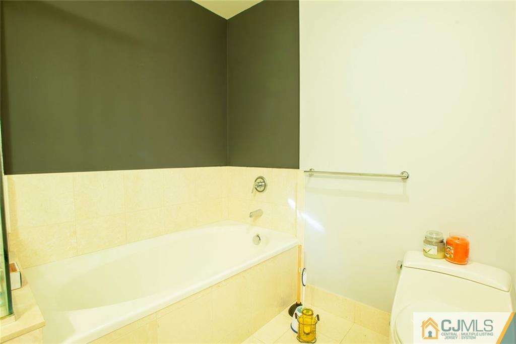 1 Spring Street, Unit 1704 New Brunswick, NJ 08901 - Photo 14 of 23 a bathroom with a bathtub and a shower