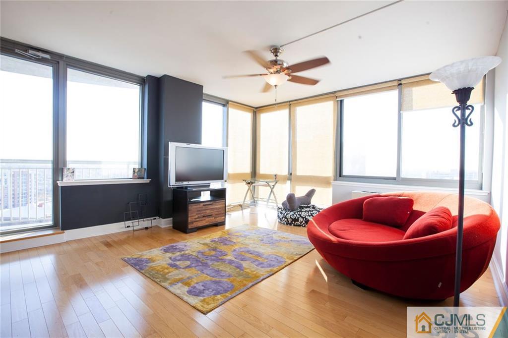 1 Spring Street, Unit 1704 New Brunswick, NJ 08901 - Photo 5 of 23 a living room with furniture and a floor to ceiling window
