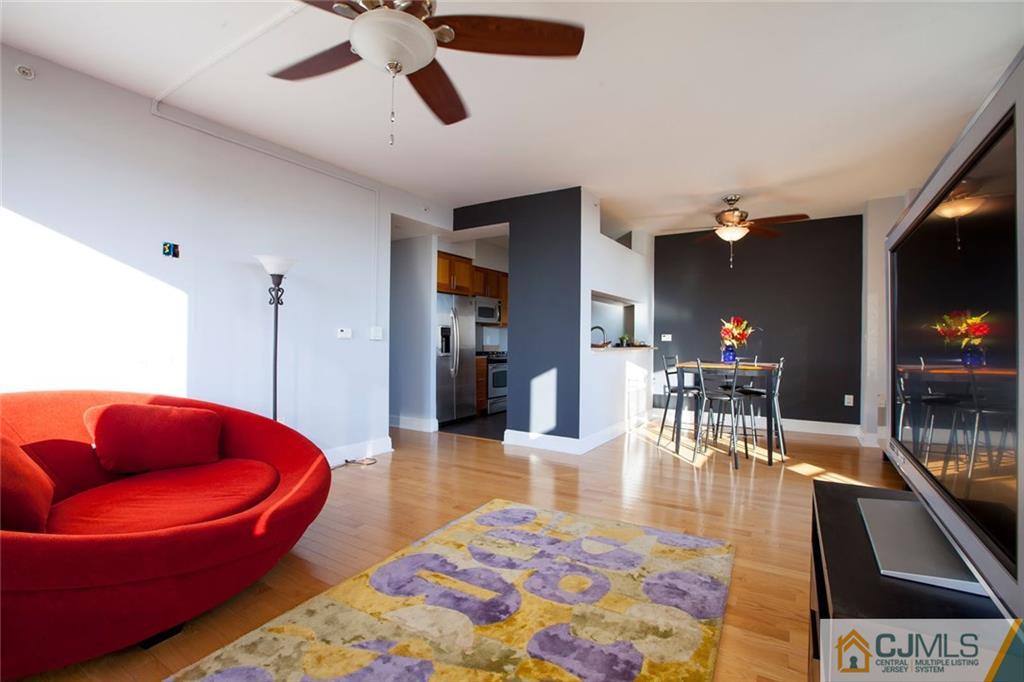 1 Spring Street, Unit 1704 New Brunswick, NJ 08901 - Photo 6 of 23 a living room with furniture and a flat screen tv