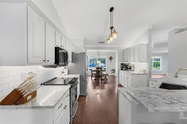 a kitchen with sink refrigerator and microwave