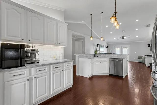 a kitchen with white cabinets and stainless steel appliances