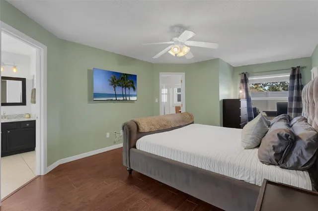a bedroom with a large bed and a chandelier