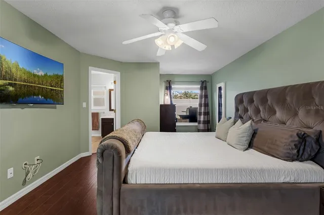a bedroom with a bed and ceiling fan