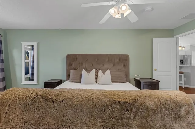 a bedroom with a bed and a chandelier