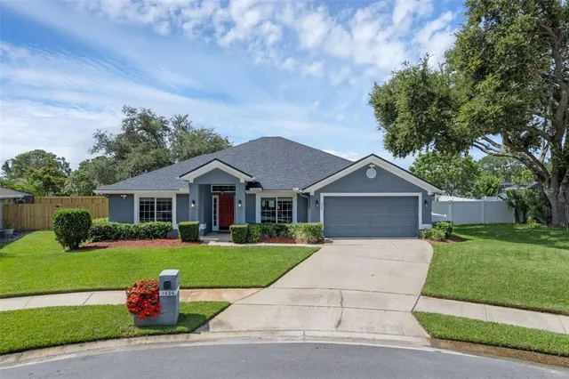 a front view of house with yard and green space
