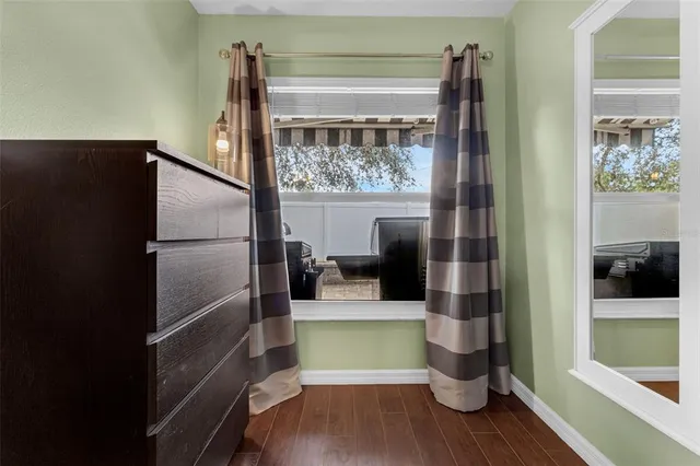 a room with wooden floor and a glass door