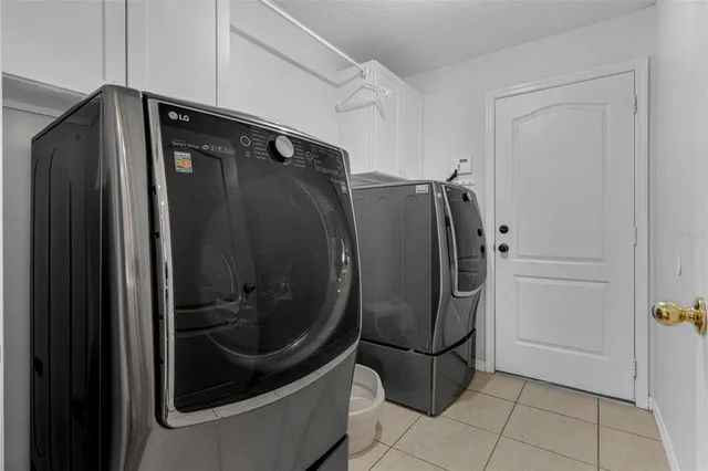 a utility room with cabinets and washer