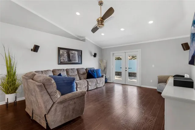 a living room with furniture and wooden floor