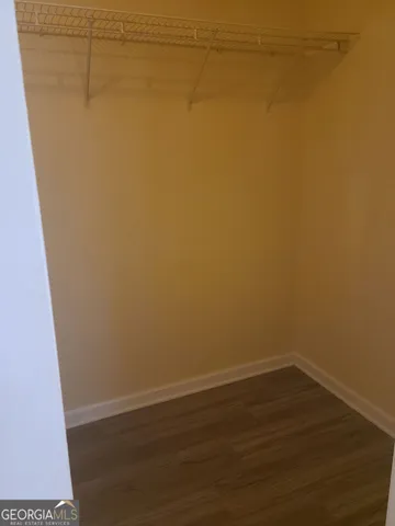 a view of a room with wooden floor