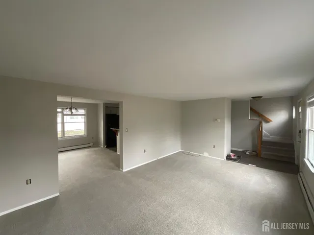 an empty room with a empty space and windows