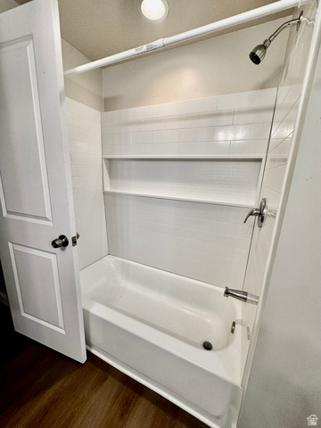 158 Cushing Way Layton, UT 84041 - Photo 10 of 14 Bathtub and shower combination featuring white subway tile surround, built-in shelving, a brushed nickel shower head, and coordinating faucet hardware