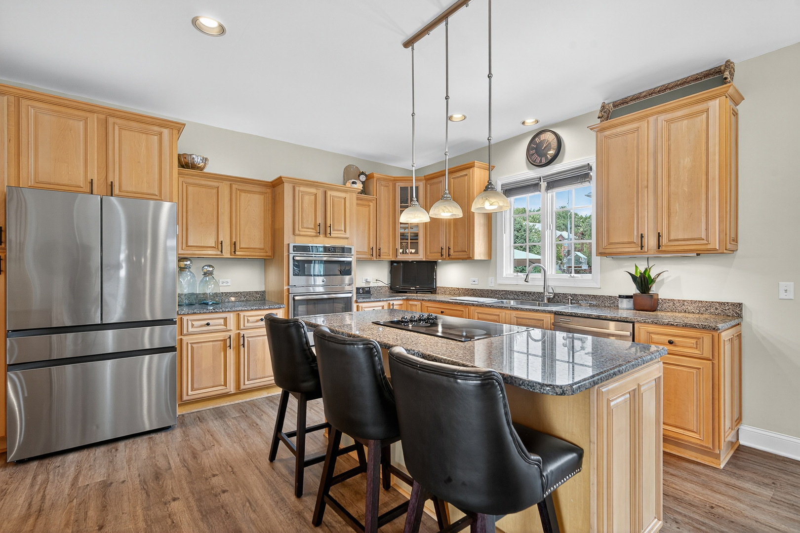 4210 Jacqueline Lane Crystal Lake, IL 60014 - Photo 9 of 48 a kitchen with stainless steel appliances granite countertop a stove a refrigerator a sink a stove and white cabinets with wooden floor
