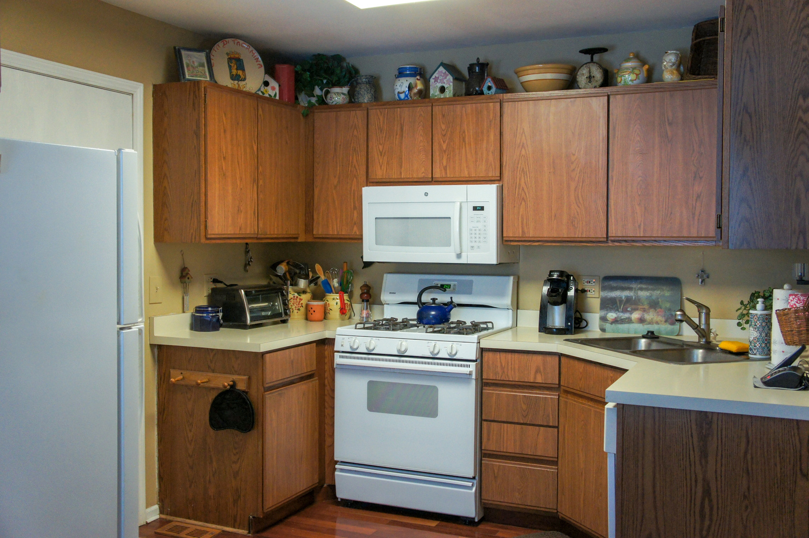 308 College Crossing, Unit 133 Rolling Meadows, IL 60008 - Photo 7 of 16 a kitchen with a stove top oven sink and cabinets
