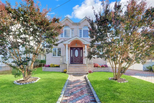 a front view of a house with garden