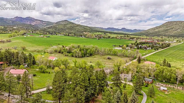 a view of a field with mountains in the background