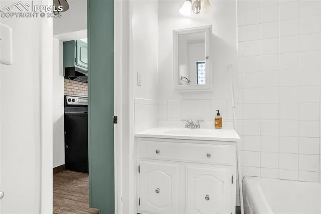a view of bathroom with a toilet sink and mirror