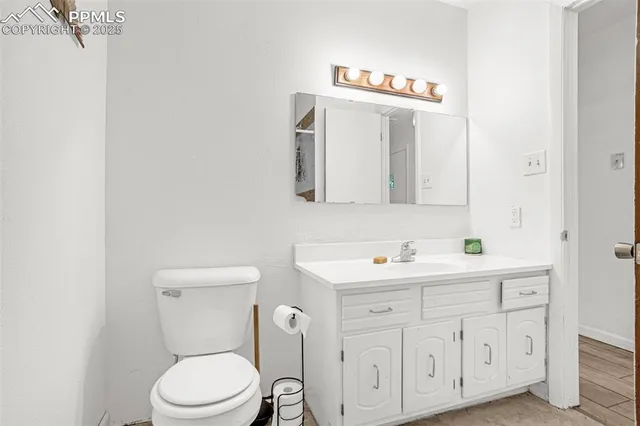 a living room with a bed windows and dresser