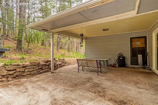 a backyard of a house with table and chairs