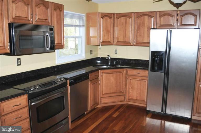 951 Waugh Chapel Road Gambrills, MD 21054 - Photo 2 of 17 a kitchen with granite countertop a refrigerator stove and sink
