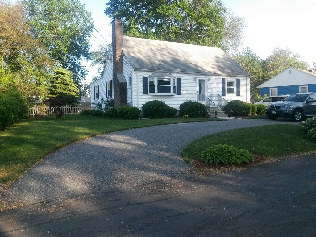 6 Robinson Road Woburn, MA 01801 - Photo 1 of 10 a front view of a house with a yard and garage