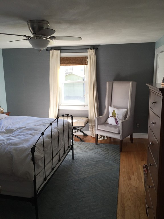 6 Robinson Road Woburn, MA 01801 - Photo 4 of 10 a bedroom with a bed and wooden floor