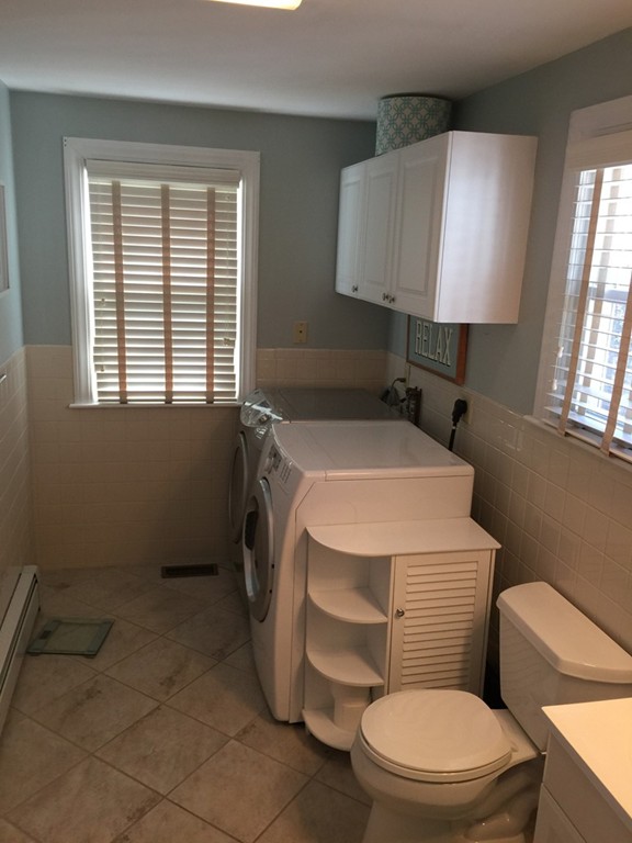 6 Robinson Road Woburn, MA 01801 - Photo 7 of 10 a white toilet sitting next to a window in a bathroom