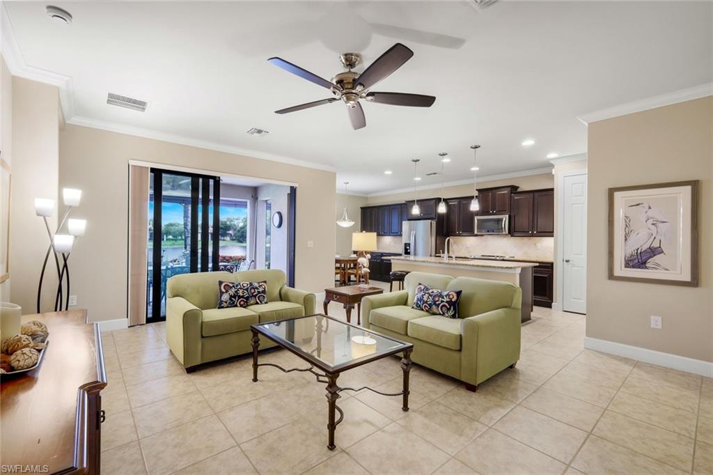 10820 Rutherford Road Fort Myers, FL 33913 - Photo 7 of 42 Spacious open-concept living area with tile flooring, a ceiling fan, and crown molding
