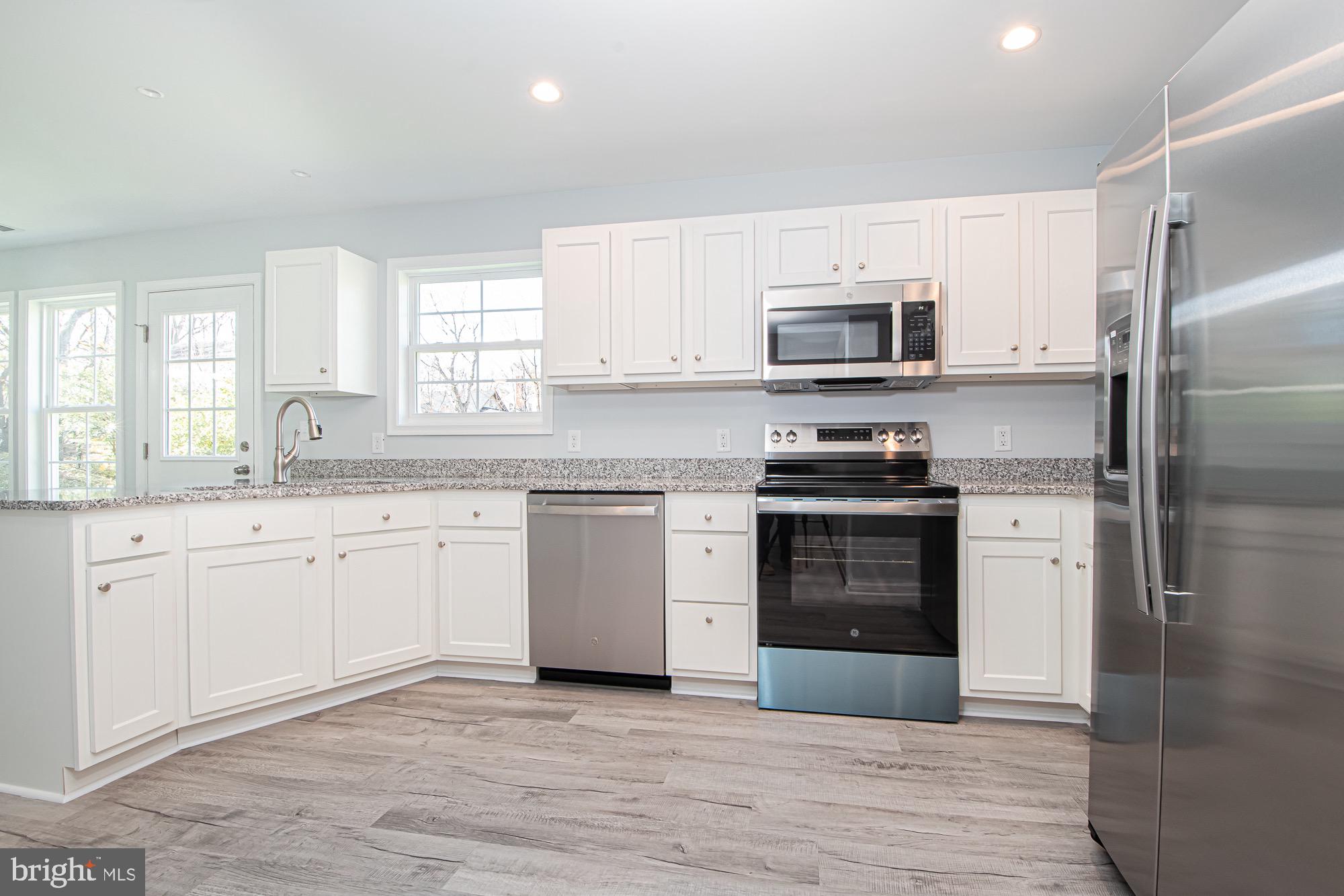 709 Ross Street Winchester, VA 22601 - Photo 8 of 40 a kitchen with granite countertop a refrigerator sink and stove