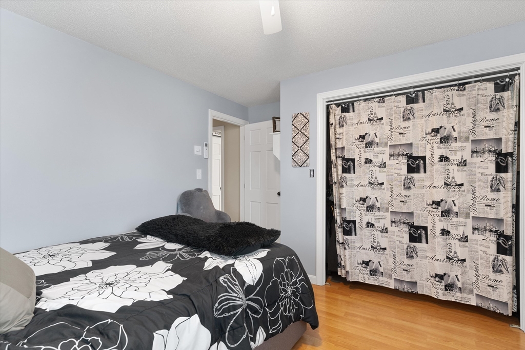 62 Valley Road Dracut, MA 01826 - Photo 16 of 35 a bedroom with a bed and wooden floor