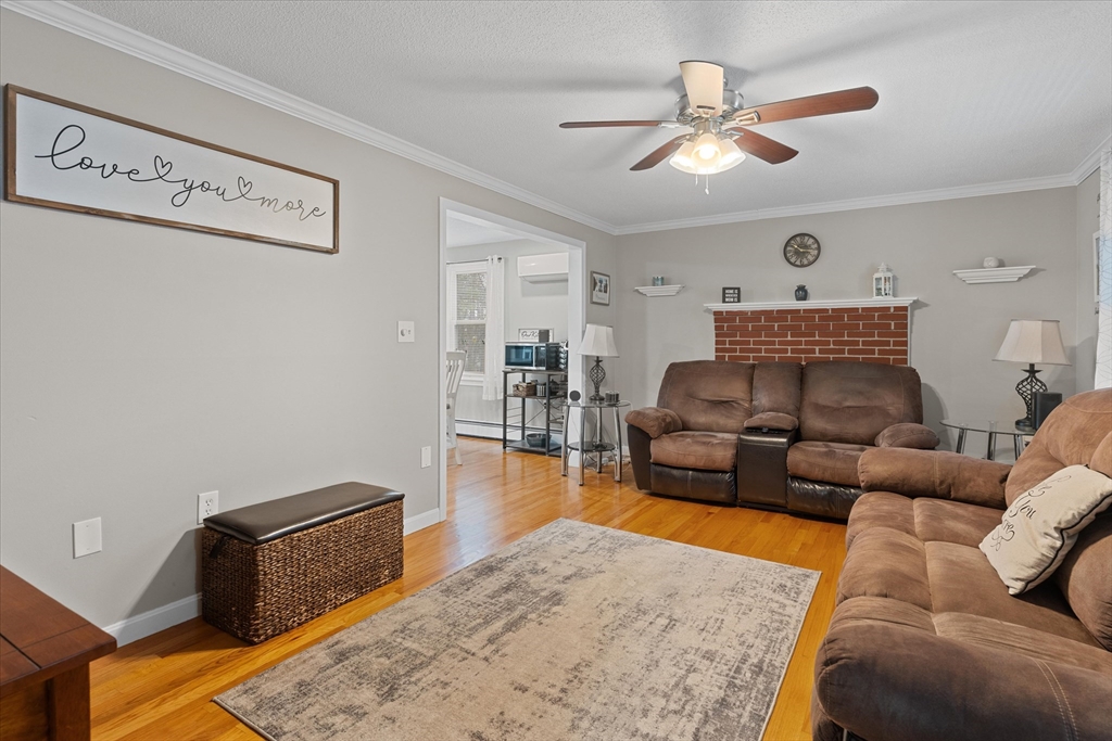 62 Valley Road Dracut, MA 01826 - Photo 4 of 35 a living room with furniture and a wooden floor