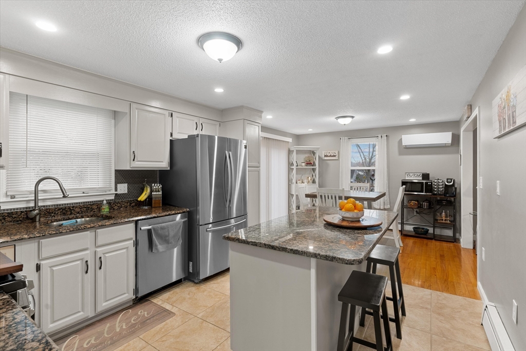 62 Valley Road Dracut, MA 01826 - Photo 6 of 35 a kitchen with sink refrigerator and cabinets